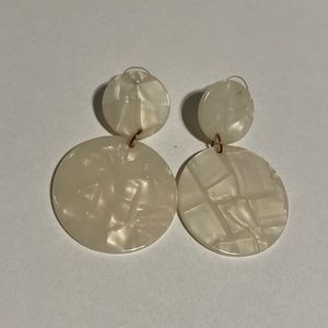White circular dangle earrings